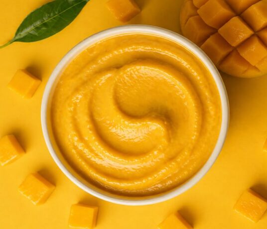 Fresh mangoes and golden mango pulp