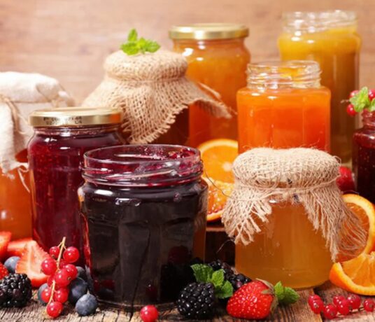 Jars of fruit jam with fresh fruit